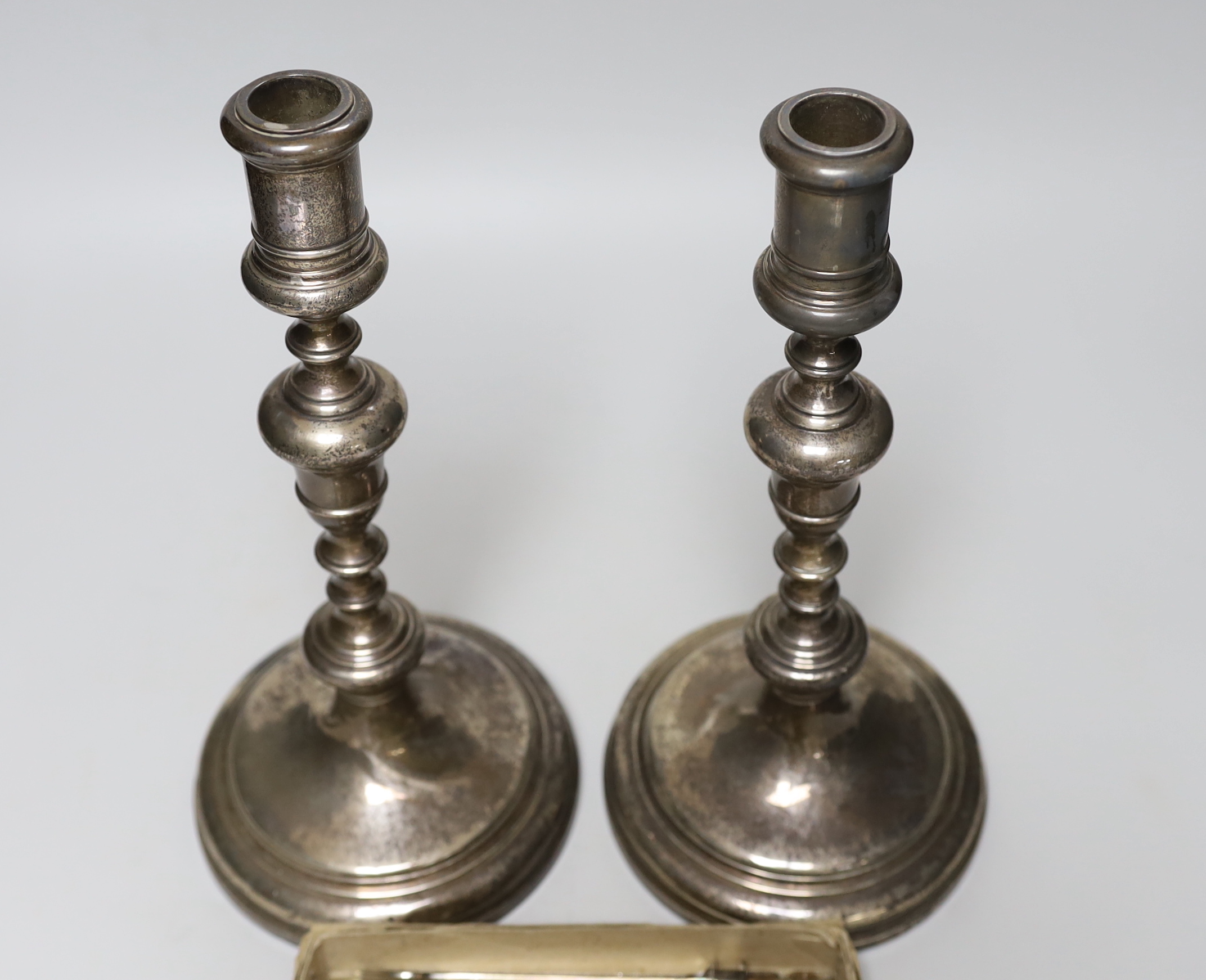 A pair of George V silver candlesticks, by William Comyns & Sons Ltd, London, 1930, height 29.6cm, weighted and eight pairs of silver fish eaters (no handles).